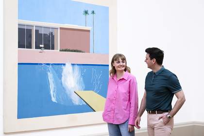 Two gallery visitors standing in front of David Hockney's A Bigger Splash painting